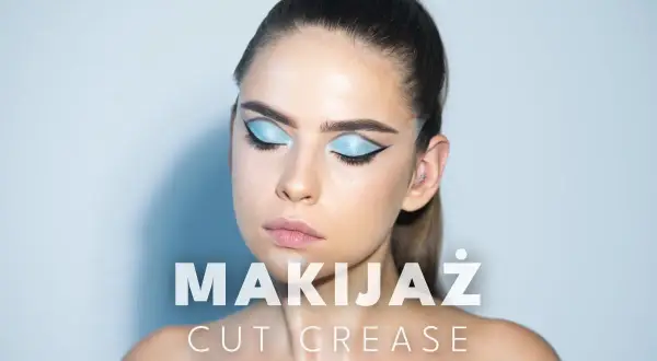 Modelka z błękitnym makijażem oczu w stylu cut crease, z wyraźną kreską i połyskującymi cieniami.